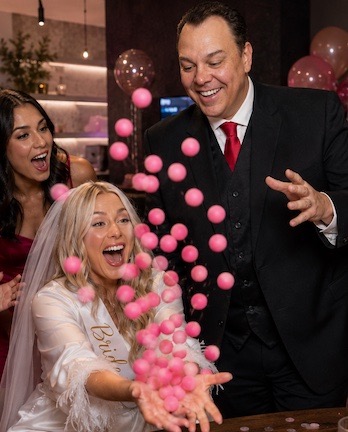 Magician performing sponge ball trick for bachelorette party.